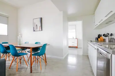 a kitchen and dining room with a table and chairs at Franklin Suites South Beach in Miami Beach