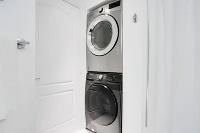 a washer and dryer in a white kitchen at 2BR Penthouse with Unbeatable Water Views and Parking in Miami