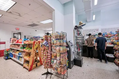 two men standing in a grocery store aisle at MIAMI Collins Beach Apartments in Sunny Isles Beach