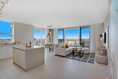 a living room with a couch and a kitchen and a living room at High Floor with Stunning Views Amazing Pools in Hollywood