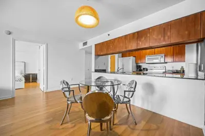 a kitchen and dining room with a glass table and chairs at Amazing cozy Condo in Brickell Miami in Miami