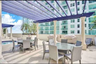 a patio with a table and chairs and a building at Amazing cozy Condo in Brickell Miami in Miami