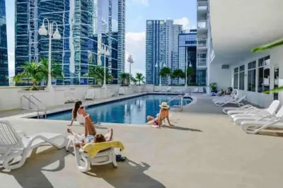 a group of people in the pool at a hotel at Amazing cozy Condo in Brickell Miami in Miami