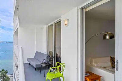 a room with a balcony with a view of the ocean at Amazing cozy Condo in Brickell Miami in Miami