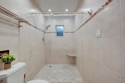 a bathroom with a shower and a toilet in it at Walk to Hollywood Beach Luxury 4BR Villa in Hollywood