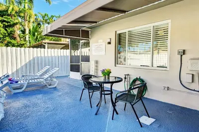 a patio with a table and chairs and a fence at Walk to Hollywood Beach Luxury 4BR Villa in Hollywood