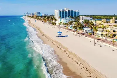 an aerial view of a beach with palm trees and buildings at Walk to Hollywood Beach Luxury 4BR Villa in Hollywood