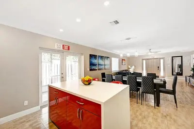 a kitchen and living room with a dining room and a table at Walk to Hollywood Beach Luxury 4BR Villa in Hollywood