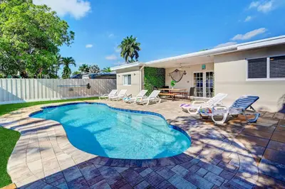 a swimming pool in the yard of a house at Great Location 5BR Heated Pool near Hollywood Beach in Hollywood