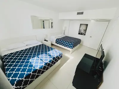 a bedroom with two beds and a television in it at Miami Hollywood Gorgeous 2BD Awesome Ocean View in Hollywood