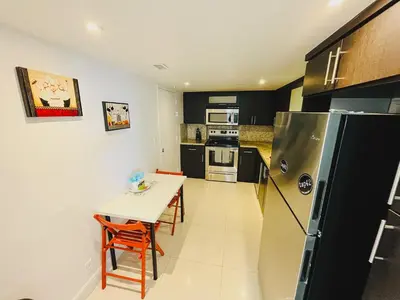 a small kitchen with a table and a refrigerator at Miami Hollywood Gorgeous 2BD Awesome Ocean View in Hollywood