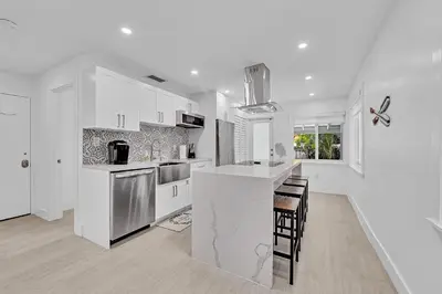 a kitchen with white cabinets and a counter top at Quiet and secluded 4 bedroom home! in Fort Lauderdale