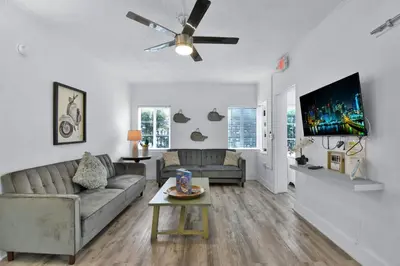 a living room with a couch and a ceiling fan at Seaheights Villa in Miami Beach