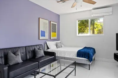a living room with a couch and a bed at Luxury House 4 beds heated Pool w Jaccuzzi in North Bay Village