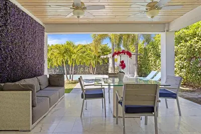 a living room with a couch and a table at Luxury House 4 beds heated Pool w Jaccuzzi in North Bay Village