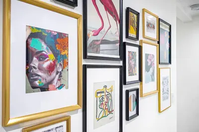 a bunch of framed art on a wall at Villa Verde Miami in Miami