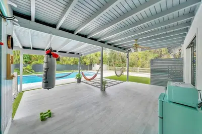 a patio with a hammock and a swing at Farmhouse Miami in Miami