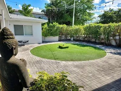 a garden with a small circle of grass in front of a house at Beautiful Apt 2/2 Near The Beach in Miami