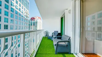 a balcony with chairs and a view of a city at Warm and Tailored 1BR w Pool Hot tub GYM Parking in Miami