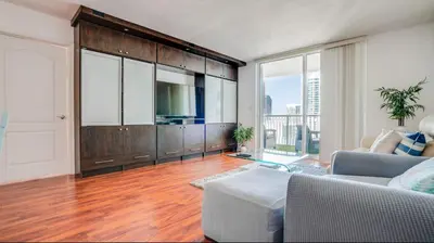 a living room with a couch and a television in a room at Warm and Tailored 1BR w Pool Hot tub GYM Parking in Miami