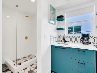 a bathroom with a blue cabinet and a shower at Rainbow Motel Miami in Miami