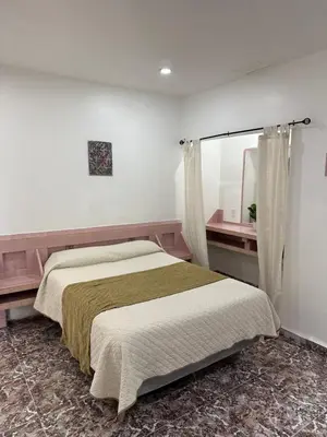 a bedroom with a large bed and a window at Rainbow Motel Miami in Miami