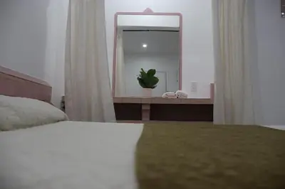 a bedroom with a bed and a large mirror at Rainbow Motel Miami in Miami