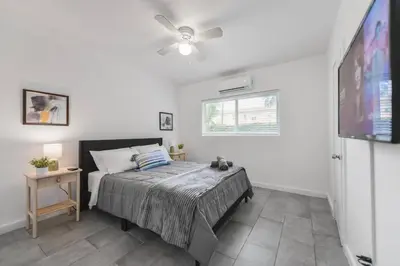 a bedroom with a bed and a flat screen tv at Great Apartment 2 BR near the beach in Miami