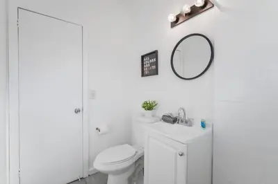 a white bathroom with a toilet and a mirror at Wonderful Studio Residence 15 min from the beach in Miami