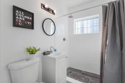 a bathroom with a toilet and a sink and a mirror at Wonderful Studio Residence 15 min from the beach in Miami