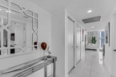 a hallway with white walls and mirrors on the wall at Luxurious Condo at ICON with Views in Miami
