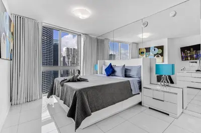 a bedroom with a bed and a large window at Luxurious Condo at ICON with Views in Miami