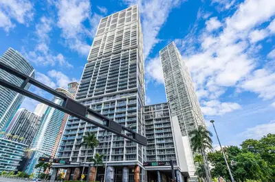 a tall building with a street sign in front of it at Luxurious Condo at ICON with Views in Miami