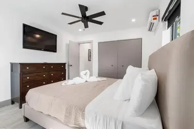 a bedroom with a large bed with a ceiling fan at Lauderdale Modern 1 Bedroom 1 Bathroom with Private Backyard in Fort Lauderdale