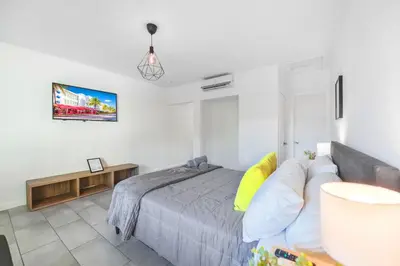 a bedroom with a bed and a couch at Lovely Studio A Few Steps From The Beach in Miami
