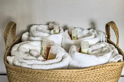 a basket with four bottles of beer and towels at Gated Southern Miami Home 22 Mi to Downtown! in Miami