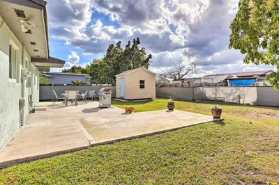 a backyard with a wooden patio and a fence at Gated Southern Miami Home 22 Mi to Downtown! in Miami