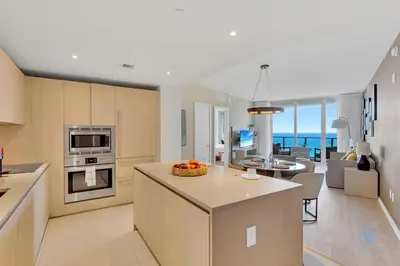 a kitchen and living room with a view of the ocean at Ocean View Balcony Beachfront Resort Amazing Pools in Hollywood