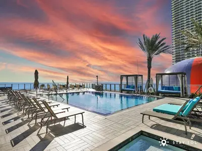a swimming pool on a building with a sunset at Ocean View Balcony Beachfront Resort Amazing Pools in Hollywood