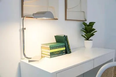 a stack of books sitting on a white shelf at Brickell House Dreams - Luxury Stay and Amenities in Miami