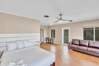 a bedroom with a bed and a couch at Sea Angel in Hollywood Beach