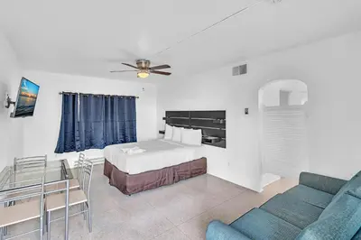 a hotel room with a bed and a couch at Sea Angel in Hollywood Beach