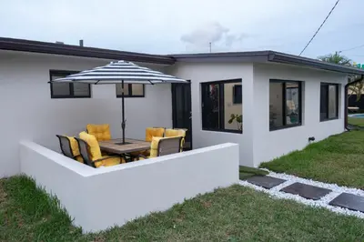 a house with a table and chairs and an umbrella at Welcome to 305 Rentals in Miami