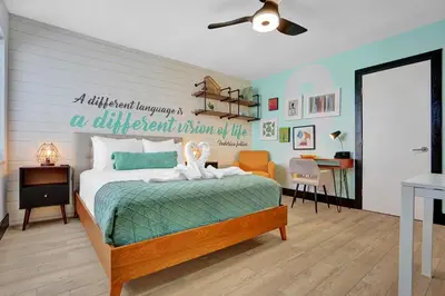 a bedroom with a bed with a sign on the wall at Hollywood Apartments Host by BeeNomad in Hollywood