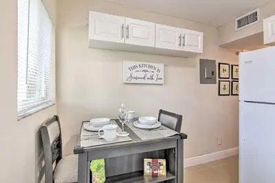 a kitchen and dining room with a table and a refrigerator at Fort Lauderdale Apt Near Beaches and Shopping! in Fort Lauderdale