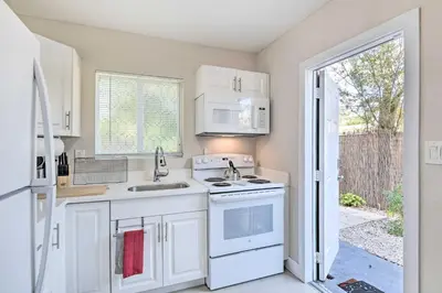 a kitchen with white appliances and an open door at Fort Lauderdale Apt Near Beaches and Shopping! in Fort Lauderdale
