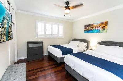 a bedroom with two beds and a ceiling fan at Premium Luxury 5BR Villa near Hollywood Beach in Hollywood