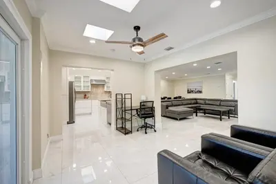 a living room with couches and a kitchen at Premium Luxury 5BR Villa near Hollywood Beach in Hollywood