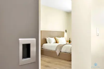 a bedroom with a bed and a tv in a room at Front Bay View Terrace Rooftop Pool Near Beach in Hollywood