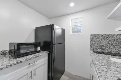 a kitchen with a black refrigerator and a counter at Beachfront Getaway Studio with Parking - M21 in Hollywood